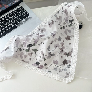 Detail of 100% cotton triangle scarf with watercolor leaves and white lace trim