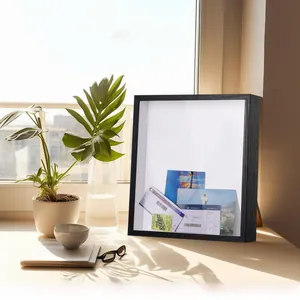 Detail of a black wooden shadow box frame storing travel tickets and postcards