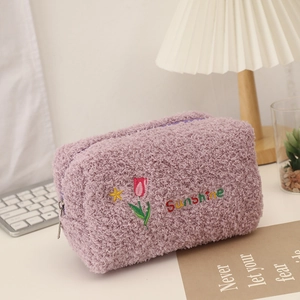Detail of purple tulip plush makeup bag with Sunshine embroidery and lamb wool texture