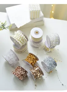 Macro shot of assorted Christmas bead chains with stars on white spools for DIY decor