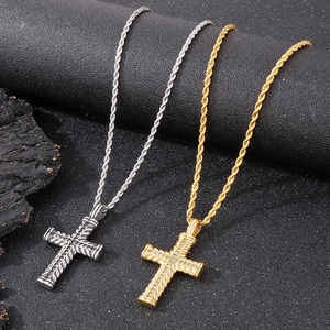 Detail of hip hop cross pendants with rope texture and diamonds in gold and silver