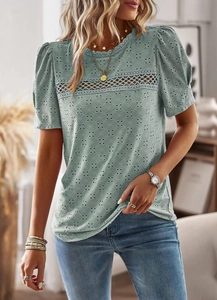 Detail of light green short sleeve top featuring lace patchwork and puff sleeves design
