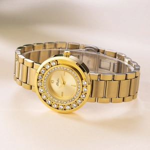 Detailed close-up of a gold ladies watch featuring a crystal bezel and metal link strap