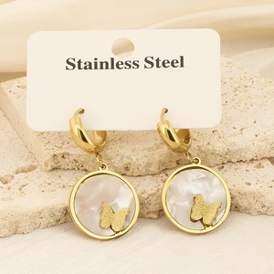 Golden stainless steel butterfly earrings with shell inlay on silk and stone background