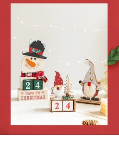 Close-up of wooden Christmas countdown calendar figurines featuring snowmen and gnomes