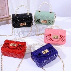 Mini jelly bags with pearl handles and quilted cutout patterns in five vibrant colors