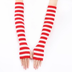 Detail of red and white striped knit long fingerless gloves with ribbed cuffs texture