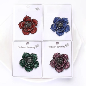 Detailed grid of crystal rose brooches in red, blue, green, and purple shades