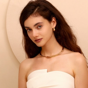 Detail of minimalist 18K gold plated choker and earrings set on model neck