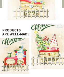 Detail of Welcome Christmas garden flag with gnomes and train patterns on burlap fabric