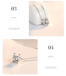Macro detail of the polished silver box chain and four-prong set sparkling zircon pendant