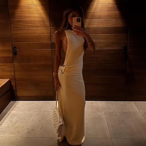 Détail de la robe de soirée beige montrant la découpe à la taille et boucle en métal