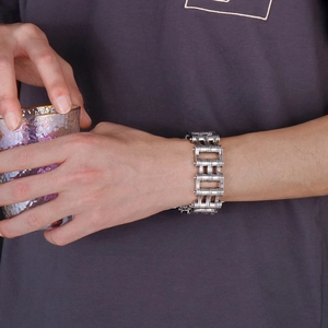Close-up of men's heavy industrial silver stainless steel chain bracelet on wrist