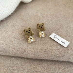 Detail of 18K gold plated bear earrings with brown flocking and white pearl accents