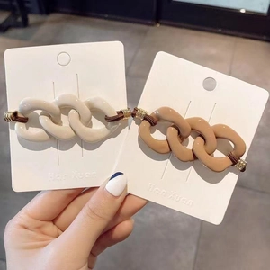 Detail of beige and khaki resin chain hair ties with high elasticity rubber bands