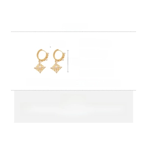 Detail view of 18K gold plated hollow star earrings with white pearls and zirconia