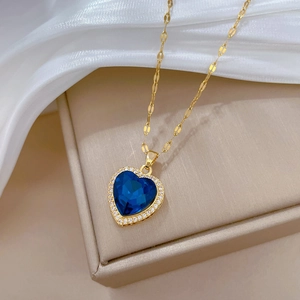 Elegant gold titanium steel necklace featuring a crystal heart pendant with blue gemstone