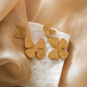 Gold plated titanium steel butterfly earrings with etched textures on marble and silk