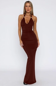 Detail of burgundy backless maxi dress featuring a deep V-neck and gold metal ring accent