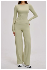 Detail of light green brushed yoga set featuring slim fit long sleeves and wide-leg pants