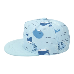 Detail of light blue kids' flat brim cap with navy whale and ocean wave pattern print