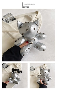 Detail of silver cat-shaped doll bag with black rivets and metal chain straps