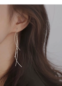 Elegant long sterling silver tassel earrings shown in a profile view on a model