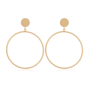 Detail showing oversized golden alloy hoop earrings with smooth metallic finish on white