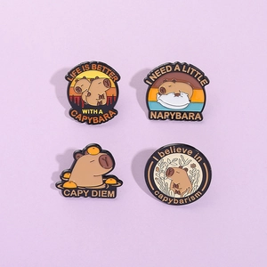 Detail of four Capybara enamel pins with text Life is Better with a Capybara