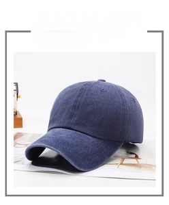 Detailed close-up of navy blue washed cotton twill baseball cap with vintage texture