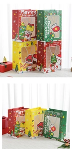 Close-up of Christmas gift bags with transparent windows and festive holiday patterns