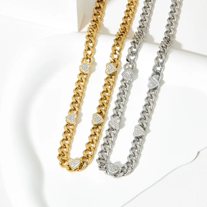 Cuban chain necklace set with zircon hearts in gold and silver finish on white background