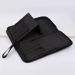 Detail view of the internal elastic slots and compartments in the black makeup brush bag