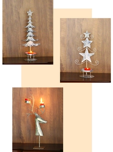 Makro-Detail von Vintage-Weihnachtskerzenhaltern aus Eisen in Baum-, Stern- und Hirschform
