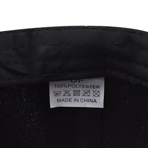 Detail shot of the internal washing label on the 100% polyester black baseball cap