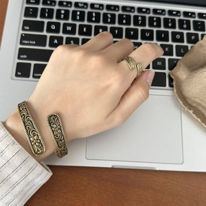 Vintage bronze-tone embossed flower cuff bracelet and ring set for women on laptop
