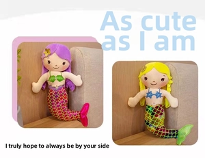 Detail of mermaid plush doll featuring colorful sequin tail and embroidered facial details