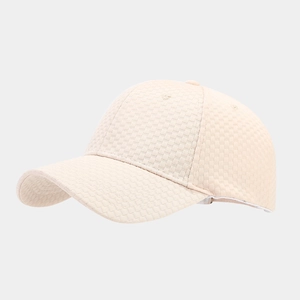 Detailed view of beige waffle knit baseball cap showing textured fabric and six-panel crown