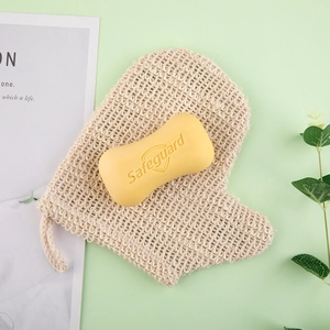 Natural linen foaming soap bag with exfoliating texture on a fresh green background