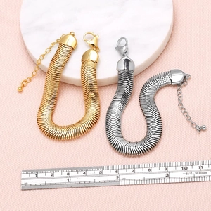 Gold and silver snake chain bracelets with lobster clasp shown with a measuring ruler