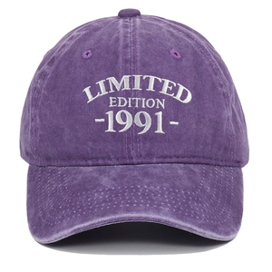 Close-up of white 1991 embroidery on washed purple cotton baseball cap fabric