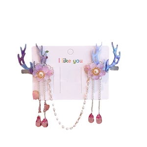 Pink and blue flower deer antler hair clips with white pearl tassels on a card