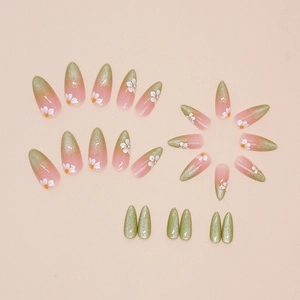 Cat eye press-on nails in almond shape with green gradient and daisy floral prints