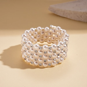 Macro detail of multi-layer baroque pearl bracelet with sparkling rhinestone accents
