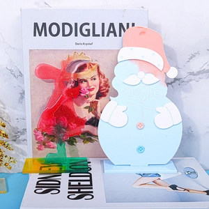 Detail of Christmas acrylic desktop ornaments with glitter reindeer and Santa Claus figure