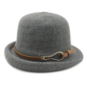 Minimalist grey knit dome bucket hat with brown leather strap and gold metal buckle