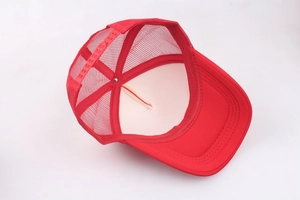 Detailed view of red mesh trucker cap featuring an adjustable snapback closure