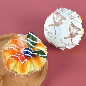 Close-up of greaseproof cupcake liners with vintage windmill pattern and bakery text