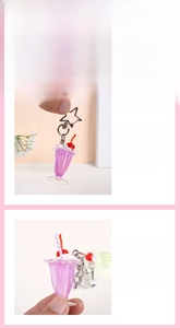 Detail of purple cream dessert keychain with star clasp, faux cherry and straw decor