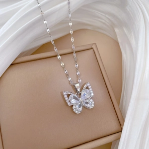 Detail of silver butterfly pendant necklace with zircon inlays on a jewelry box